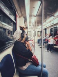 Full length of woman traveling in train