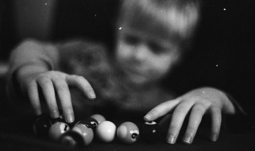 Close-up of boy holding small pool balls