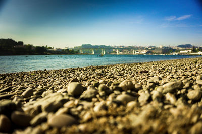 Surface level of sandy beach against blue sky