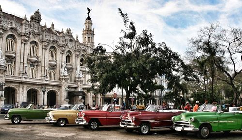 Vintage cars parked on street in city