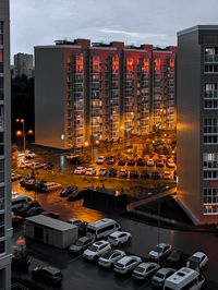 High angle view of illuminated buildings against sky in city