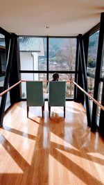 Rear view of woman on chair at home