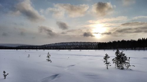 Frozen landscape against sky during winter