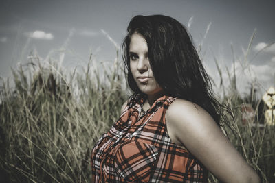 Portrait of beautiful woman on field