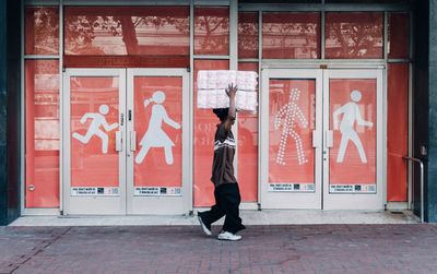 Full length of woman standing on wall