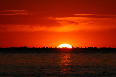 Scenic view of sea against romantic sky at sunset