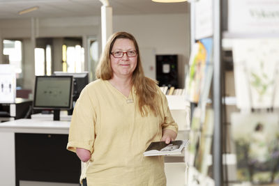 Portrait of librarian holding a book