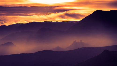 Scenic view of silhouette mountains against sky during sunset