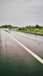 Road by landscape against clear sky