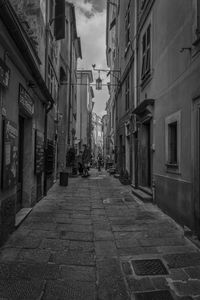 Empty alley amidst buildings in city