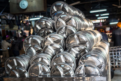 Steel plates arranged in large container at restaurant