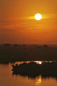 Scenic view of sea against orange sky