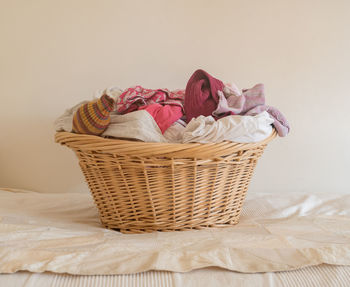 Close-up of wicker basket on bed at home