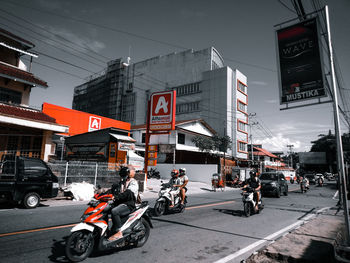 Vehicles on road by buildings in city