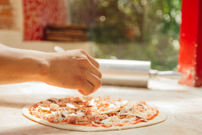 Cropped hand of person preparing food