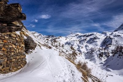 Scenic view of snow covered mountains against sky