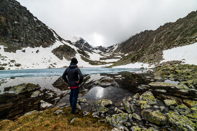 Rear view of man standing on mountain