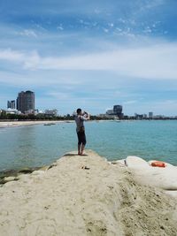 Full length of man on beach against sky