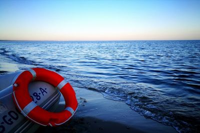 Close-up of red boat on sea against clear sky