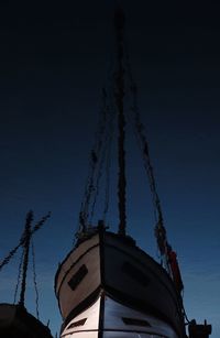 Low angle view of silhouette built structure against sky at night