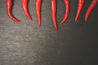 High angle view of red chili peppers on black background