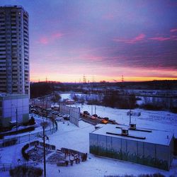 Snow covered landscape at sunset