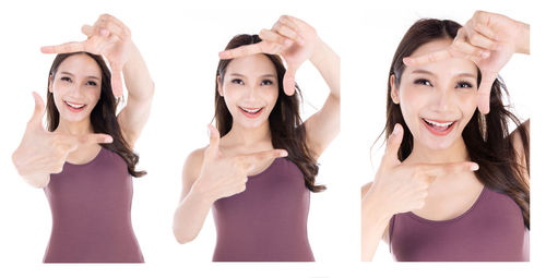 Portrait of smiling young woman against white background