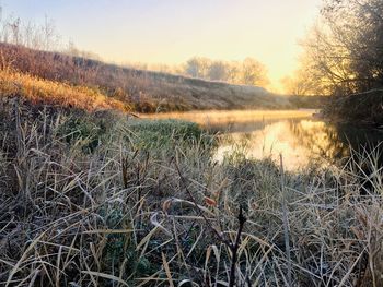 Scenic view of lake against sky during sunset
