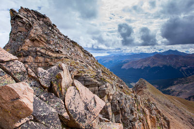 Scenic view of mountains against cloudy sky