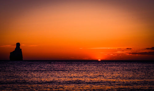 Scenic view of sea against orange sky