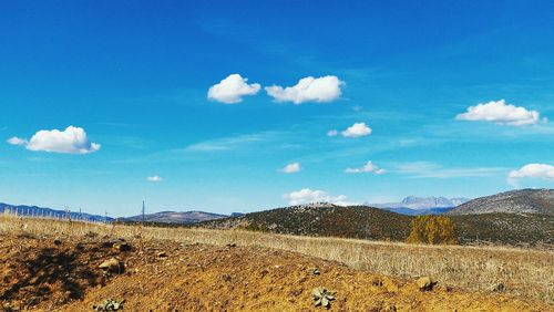 Scenic view of mountains against blue sky