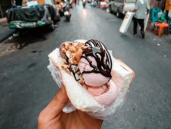 Midsection of ice cream on street