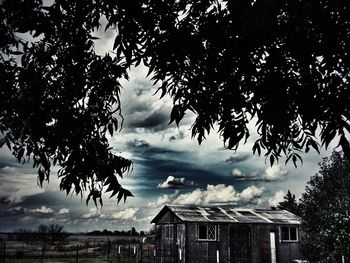 Low angle view of building against cloudy sky