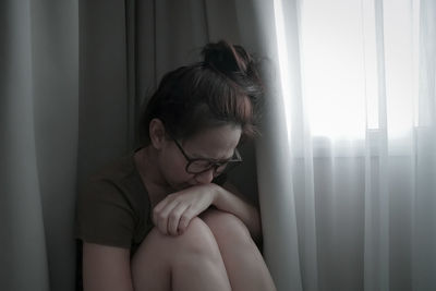 Young woman sitting at home