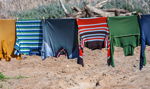 Row of hooded chairs on beach