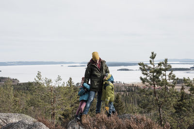 Father and his kids enjoying hiking together and the ocean view