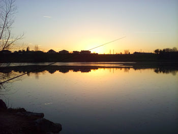 Scenic view of lake against orange sky