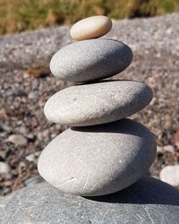 Close-up of stone stack on rock at beach