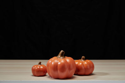 Close-up of tomatoes on table against black background