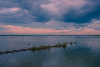 Scenic view of beach against sky during sunset