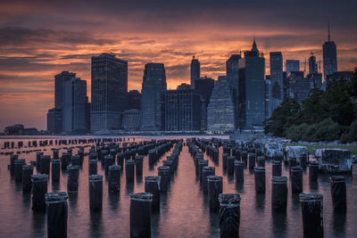 View of modern buildings in city during sunset