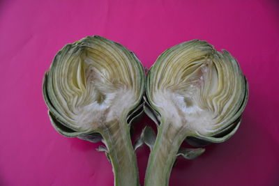 Close-up of sliced artichoke on pink background