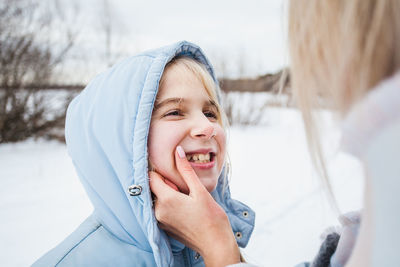 Portrait of smiling woman in snow