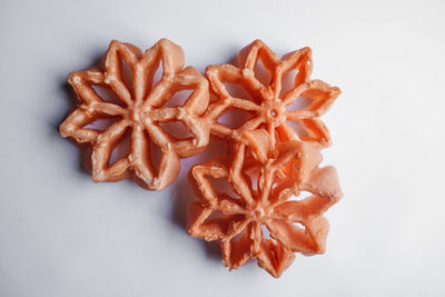 High angle view of orange fruit against white background