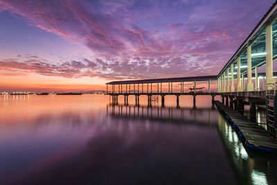 Pier over river during sunset