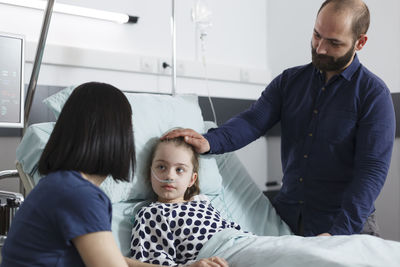 Father consoling daughter at hospital