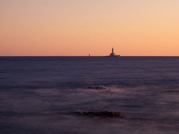 Scenic view of sea against clear sky during sunset