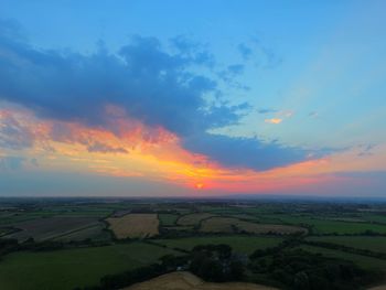 Scenic view of field against cloudy sky