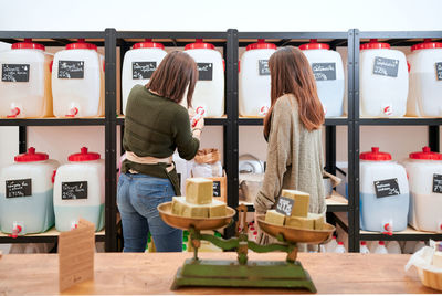 Rear view of women standing at store