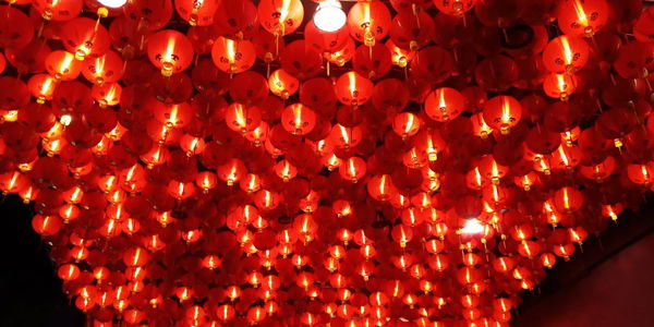 Close-up of illuminated lanterns hanging at night